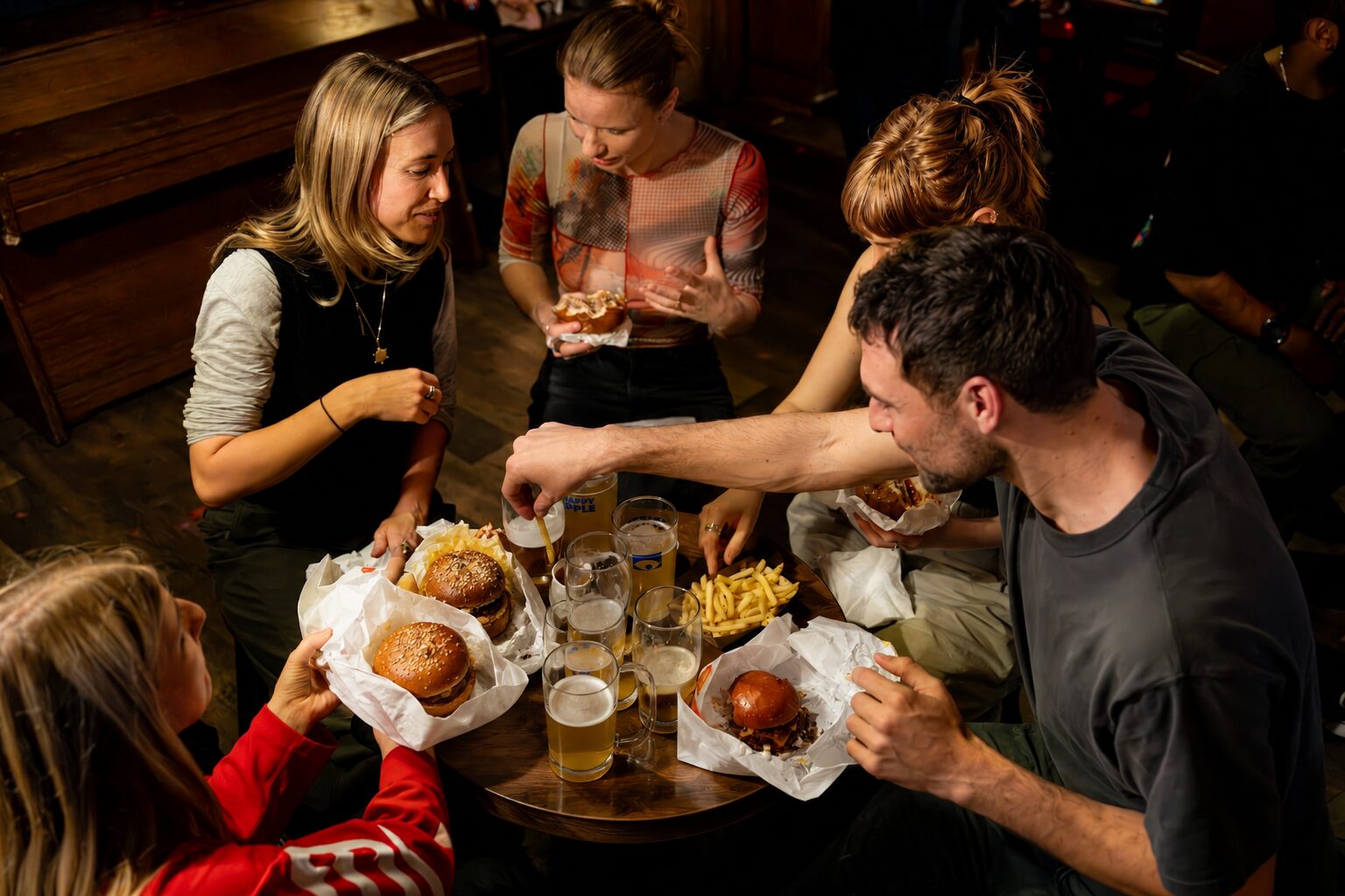 Friends sharing burgers at a pub residency