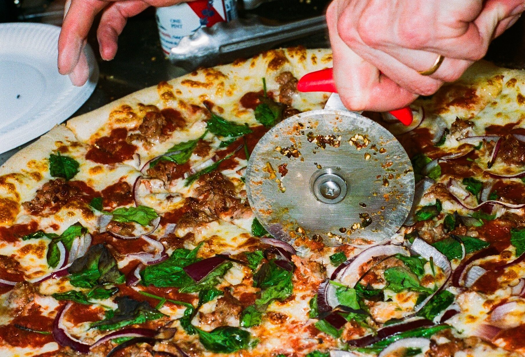 Pizza being cut at a pub residency